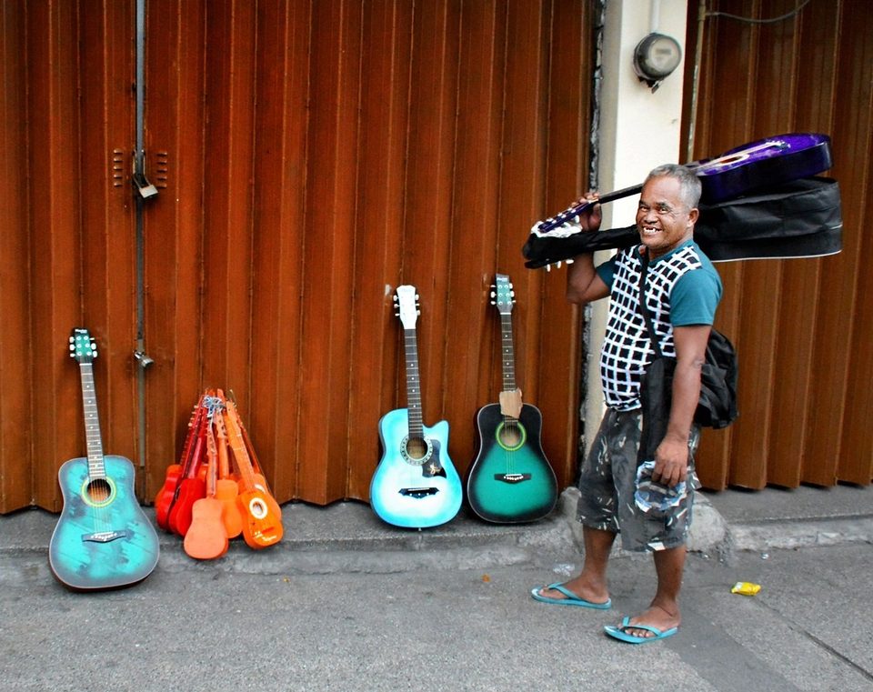 Guitar seller, streets of Manila, PHILIPPINES