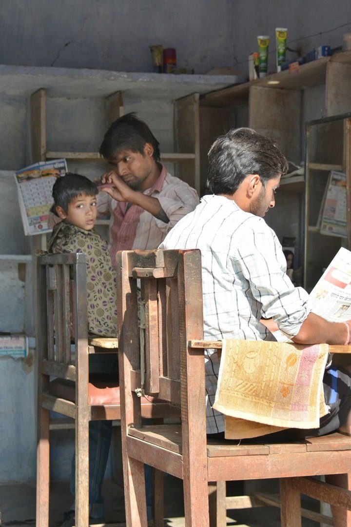 a boy at the barber, Abhaneri village, INDIA