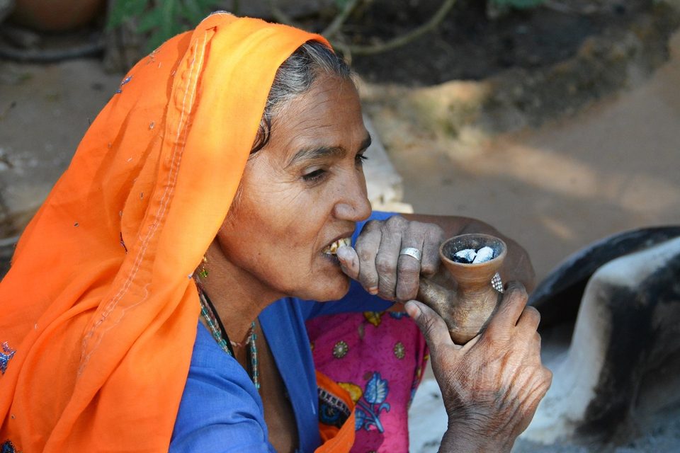 Abhaneri village woman smoking clay pipe
