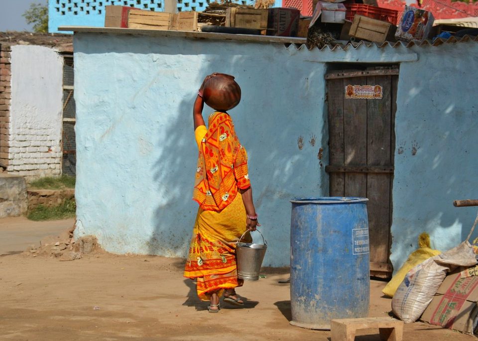 A woman carrying milk - daily life in Abhaneri village